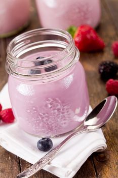 Small jars with homemade yogurt with berries