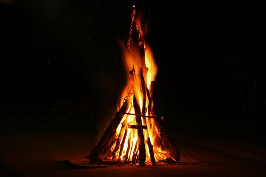 Flames of a campfire in the night