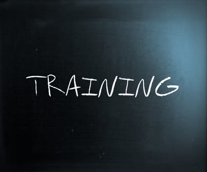 "Training" handwritten with white chalk on a blackboard.