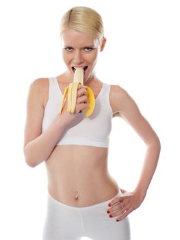 Starving sexy woman eating banana