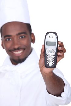 Smiling afro-American caterer with telephone, studio shot