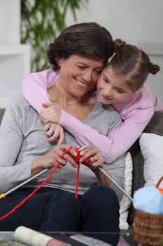 Grandma knitting with her grandchild