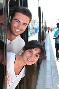 Couple leaning out of tram