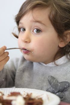 Portrait of a little girl eating
