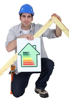 Carpenter kneeling with energy efficiency banner