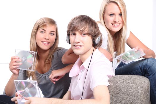 Teenagers listening to CDs on headphones