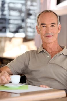 Senior man drinking a cup of expresso
