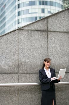 businesswoman outdoors with notebook