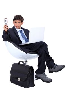 Young boy dressed as a surly businessman