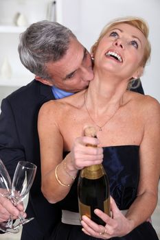 Man kissing his wife's neck