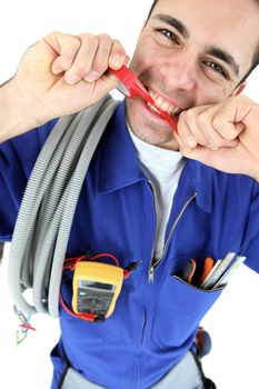 Electrician biting piece of plastic