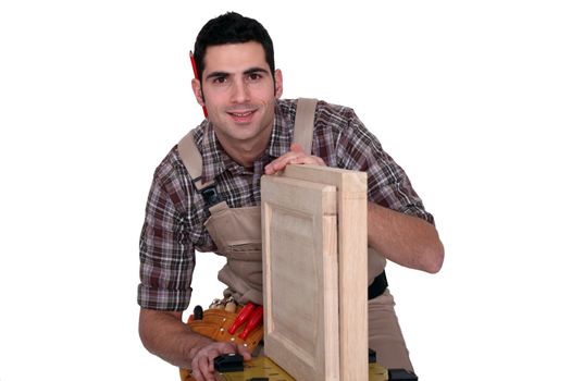 A carpenter working on a closet door.