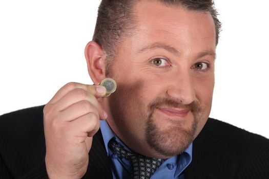 Man holding a one Euro coin