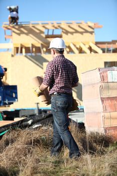 Roofer working on unfinished house