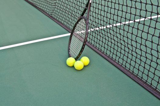 Tennis Court with racket and balls on net
