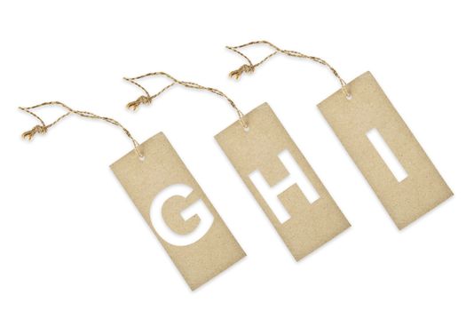 Brown paper tag with letter G H I cut