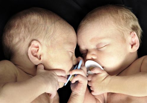 New born twins with dummies