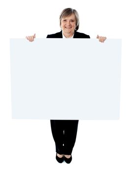 Businesswoman holding a blank poster