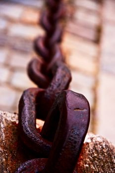 Old forged chain on quay 