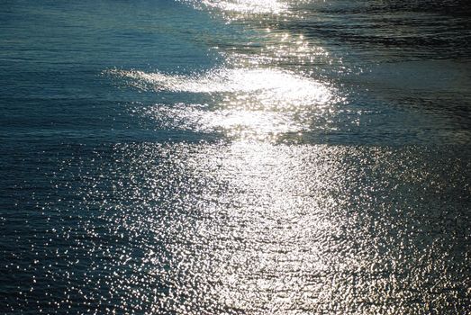 Close-up view of the blue sea with reflections of sun rays
