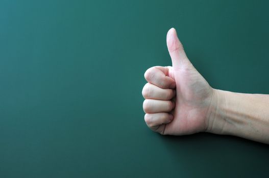 Thumb up on a blackboard background