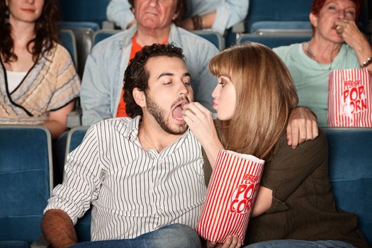 Woman Feeds Boyfriend at Movie