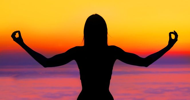 Yoga woman over sunset