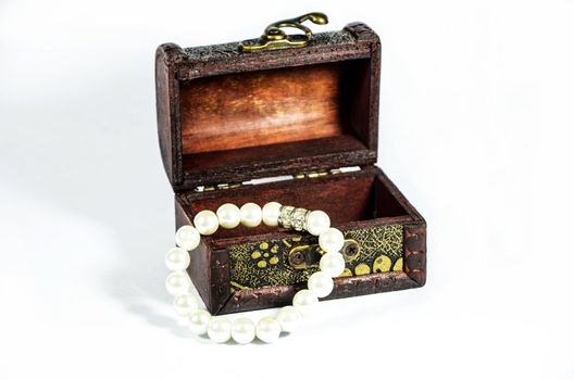 Steel box with pearls on white background