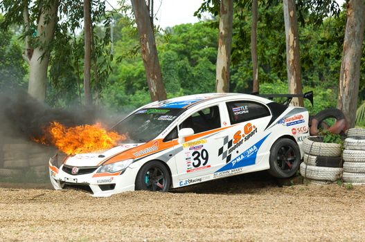 PATTAYA - JUNE 17: Honda Civic with driver Pattarapon on fire in the gravel trap during a touring car race at Bira Circuit, Pattaya, Thailand on June 17, 2012.