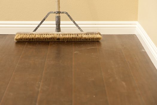 Push Broom on a Newly Installed Laminate Floor and Baseboard