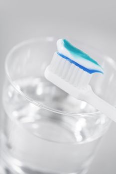Toothbrush with toothpaste and a glass of water