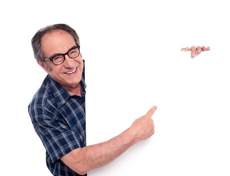 Man pointing at white blank poster