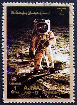 AJMAN - CIRCA 1973: a stamp printed in the Ajman shows Edwin Buzz Aldrin Walks on the Surface of the Moon, Moon-landing, Apollo 11, circa 1973