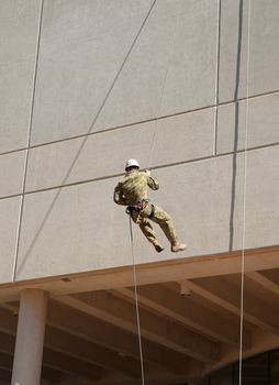 abseiling down the wall