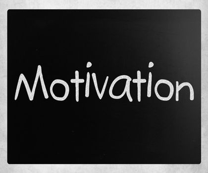 "Motivation" handwritten with white chalk on a blackboard