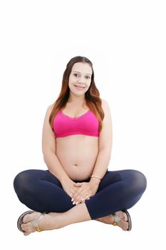 Pregnant woman sitting in floor smiling