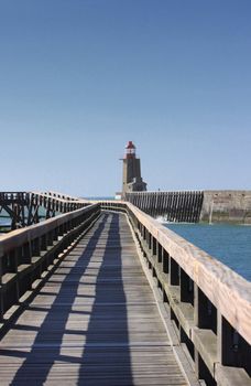 wooden pier and  lighthouse of the port of f�camps in normandy france