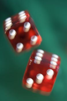 Pair of red dice being thrown