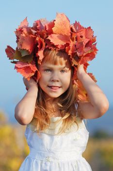 Cute little child girl in sunny autumn