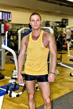 Portrait of handsome bodybuilder in fitness club