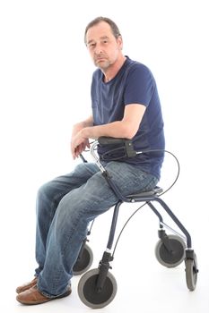 Depressed man sitting on medical walker 