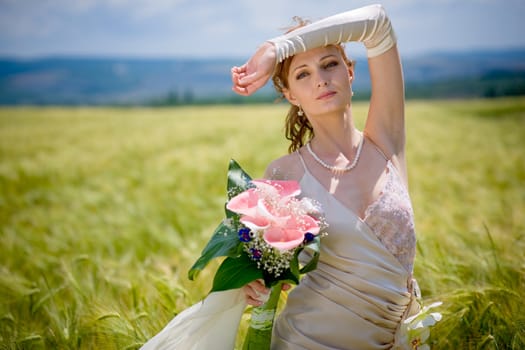 Bride posing in field