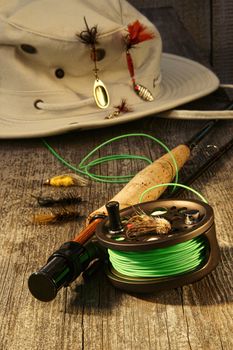 Fishing reel and hat on bench