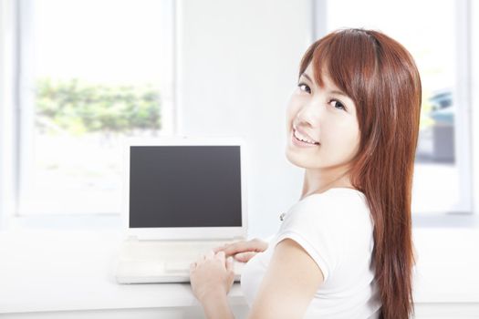 happy young woman using the laptop at home
