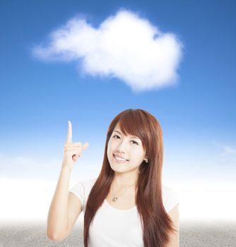 smiling young woman pointing to the cloud