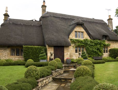 Beautiful upper class cottage with thatched roof and a pretty garden in the village of Chipping Campden, Cotswold, United Kingdom.
