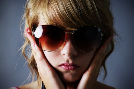 Blond girl with large sunglasses