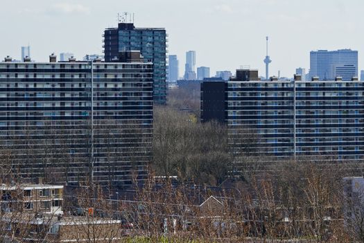 View over suburb Vlaardingen, the Netherlands, with appartment buildings and skyline Rotterdam with Euromast in background