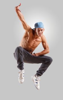 young man in a blue cap dancing hip hop