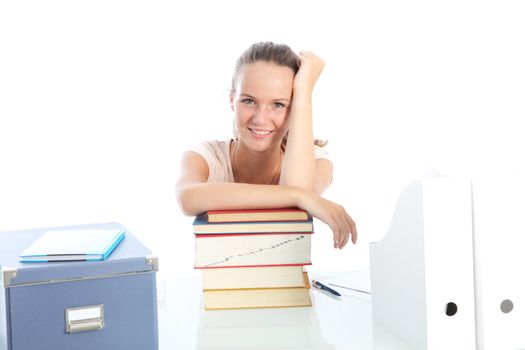 Smiling female student sitting at her desk relaxing with her arms on top of a pile of textbooks on a white background Smiling female student sitting at her deskrelaxing with her arms on top of a pile of textbooks on a white background 